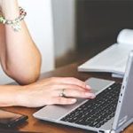 woman browsing website on laptop