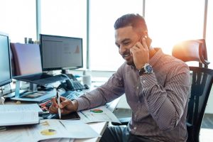 Man in the office using the best phone etiquette