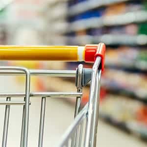 Empty shopping cart in an aisle of a grocery store