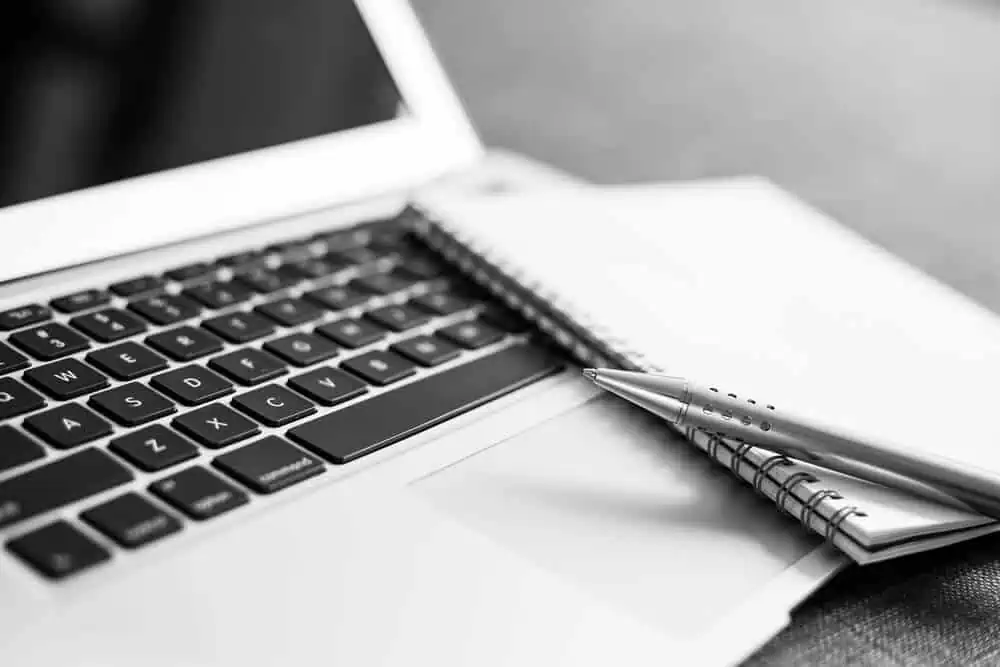 baton rouge professional copywriter brainstorming with a laptop and a notepad and pen