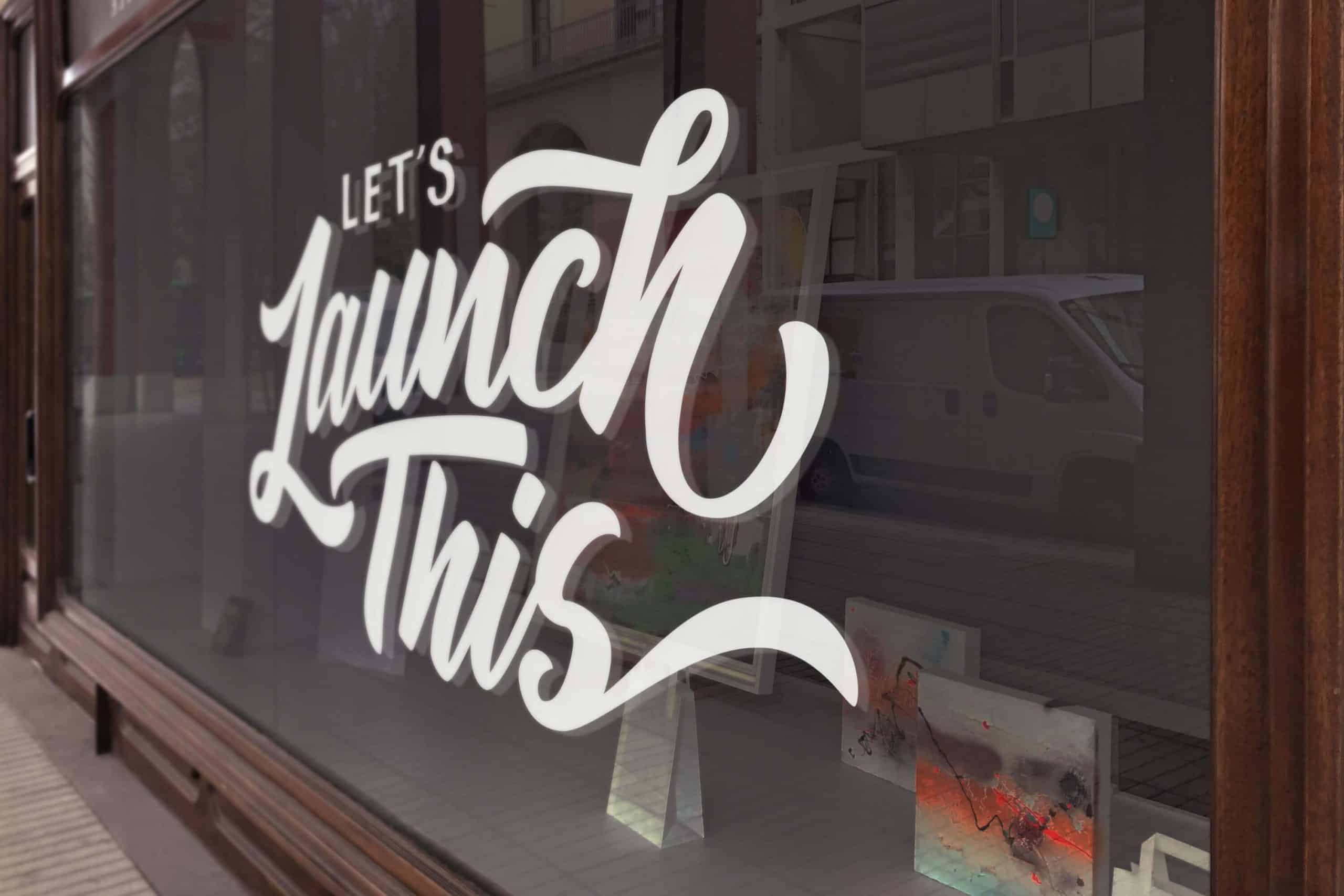 lets launch this sign printed on window of digital marketing company's window