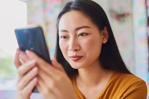 a woman researching SEO beyond content on her phone