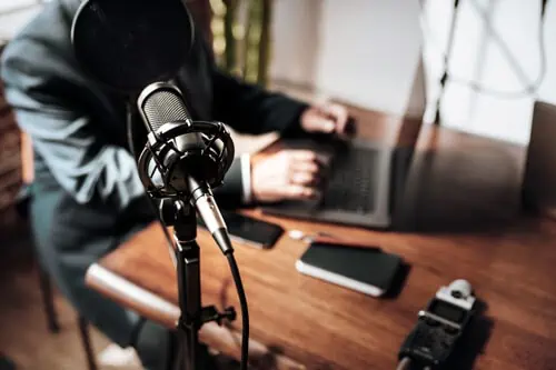 a person recording into the microphone for their business podcast