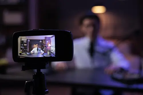 a business owner recording a podcast on a camera 