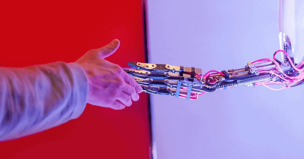 a human hand shaking a robot hand