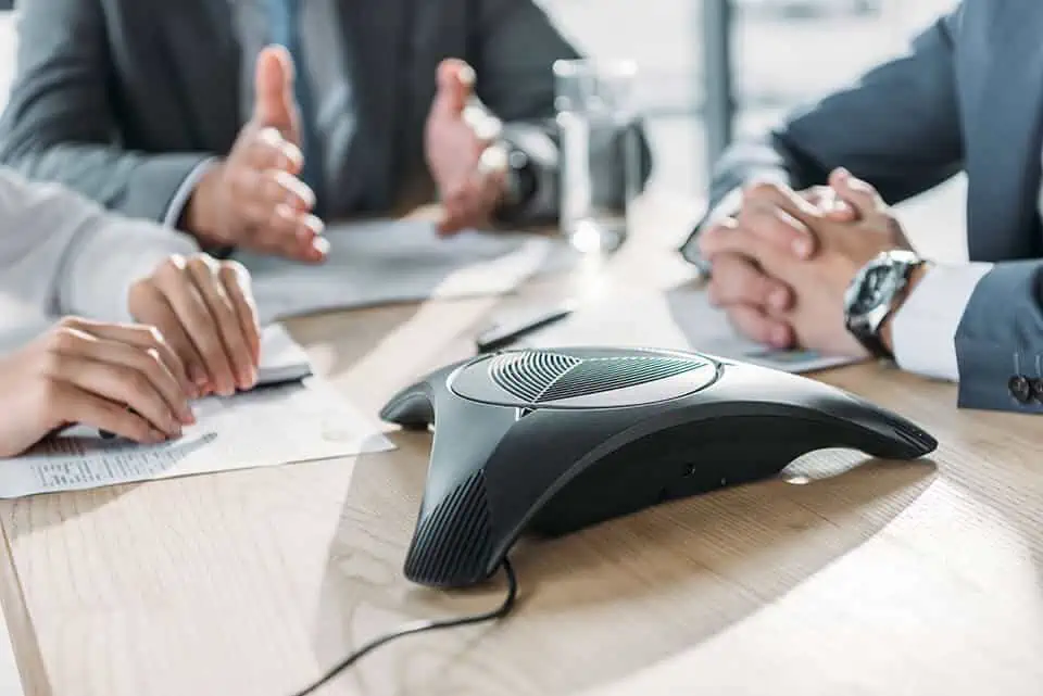 business phone system in use at conference table